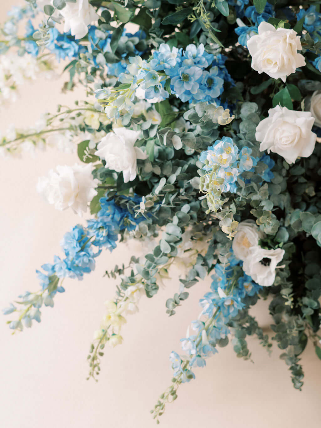 The Aurora Full Collection featuring blue delphinium and white roses in a picturesque floral arrangement.